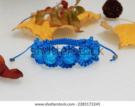 Aquamarine friendship bracelet and leafs. Beautiful aquamarine bracelet on a white
