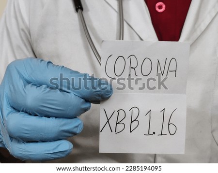 Picture of a doctor wearing a white apron and blue gloves with a stethoscope is holding a placard with Corona XBB1.16 written on it. New Strain of corona virus. Covid-19 infection Royalty-Free Stock Photo #2285194095
