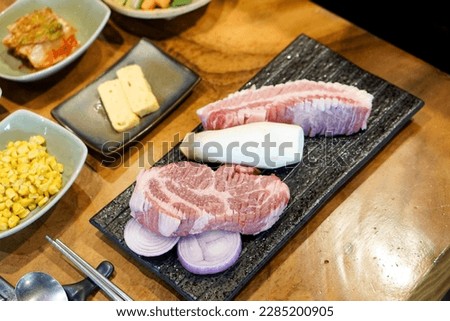 Raw pork belly and pork neck slices - Prepare for Grill over hot charcoal stove, also know as Samgyeopsal Gui, Korean BBQ style, The traditional Korea street food, Selective focus. Royalty-Free Stock Photo #2285200905