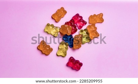 Colorful gummy bear candies on pink background. Top view. Royalty-Free Stock Photo #2285209955
