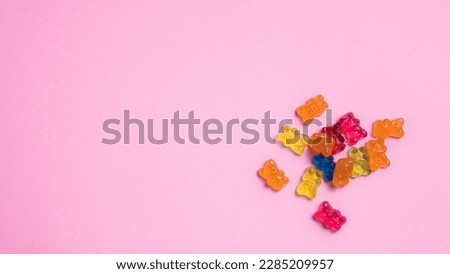 Colorful gummy bear candies on pink background. Top view. Royalty-Free Stock Photo #2285209957