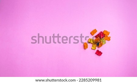 Colorful gummy bear candies on pink background. Top view. Royalty-Free Stock Photo #2285209981