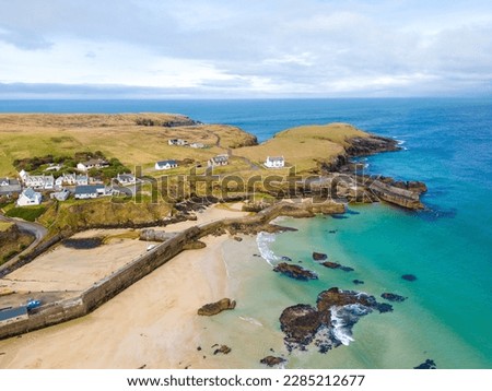 Aerial drone view of Port of Ness on the Isle of Lewis in the Outer Hebrides. Beautiful landscape of beach and sea on sunny day. Royalty-Free Stock Photo #2285212677