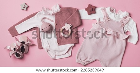 Set of pink clothes and accessories fot newborn girl. Toys, bodysuit, romper, knitted cardigan, shoes, bib on pastel background. Mock up tor text. Baby shower concept. Flat lay, top view. Royalty-Free Stock Photo #2285239649