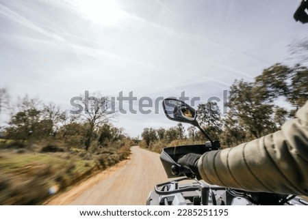 Stock photo of woman driving a quad in the countryside