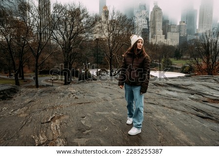 Teen girl looking at skyline on cloudy day