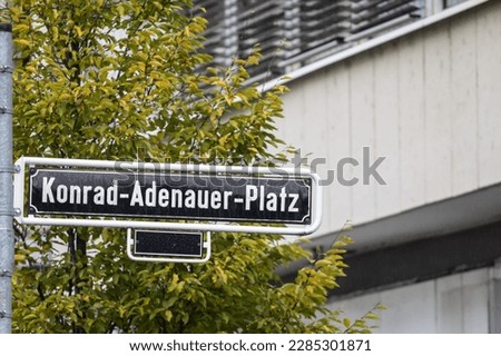 Selective blur on a street sign indicating Konrad Adenauer Platz square, one of the main squares of Dusseldorf city center dedicated to konrad adenauer, former christian democrat chancellor of germany