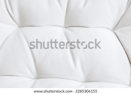 Close up white mattress sofa texture. Backdrop surface for design art work. Furniture tufted pattern wallpaper.