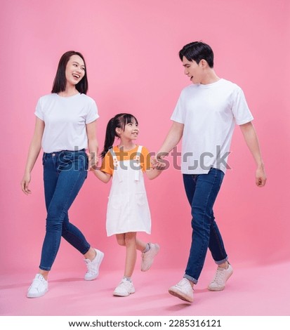 Young Asian family on background Royalty-Free Stock Photo #2285316121
