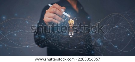 Creative solution or idea for web banner design or landing page template for a creative agency with a pen handle with a light bulb and colorful abstract geometric shapes and leading lines. Royalty-Free Stock Photo #2285316367