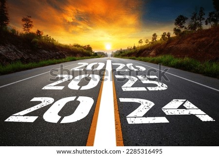 Text 2024-2026 written on the road in the middle of asphalt road with at sunset. Concept of planning, goal, challenge, new year resolution,noise, selective focus Royalty-Free Stock Photo #2285316495