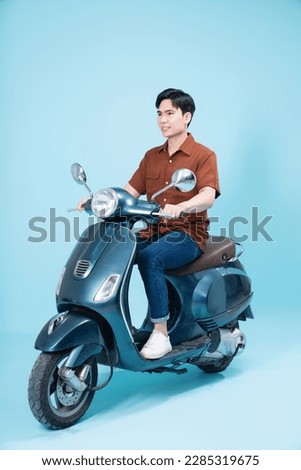 Image of yougn Asian man on motorbike Royalty-Free Stock Photo #2285319675