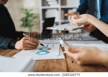 Asian business advisor meeting to analyze and discuss the situation on the financial report in the meeting room.Investment Consultant, Financial , teamwork ,brainstorming ,startup and accounting. Royalty-Free Stock Photo #2285326771