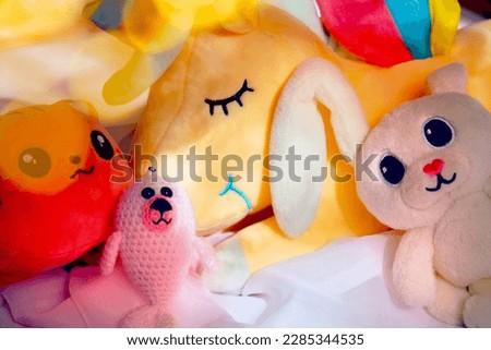 Cute kids toys on shelf in the bedroom, playroom. Morning sunlight, flare bokeh