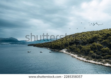 Marjan Hill on an Adriatic Island with this aerial view before the storm. The rugged coastline and dense forest provide a dramatic backdrop to the tranquil sea.