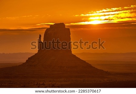 "Monument Valley" - a stunning natural formation of red sandstone buttes, mesas, and spires that rise dramatically from the desert floor, located on the Navajo Nation Reservation Royalty-Free Stock Photo #2285370617