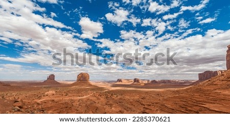 "Monument Valley" - a stunning natural formation of red sandstone buttes, mesas, and spires that rise dramatically from the desert floor, located on the Navajo Nation Reservation Royalty-Free Stock Photo #2285370621