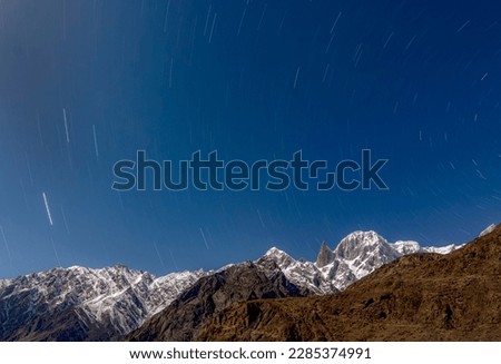 beautiful night photography of landscape with snow peak and blossom trees 