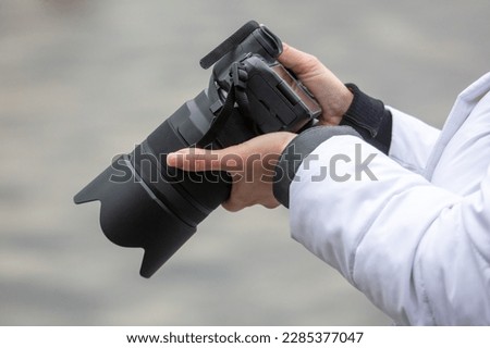 Professional camera in the hands of a girl. Close-up