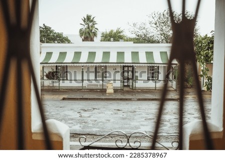 Experience the charm of a white historical craft house at Die Tuyshuise on Market Street in the great Karoo town of Cradock, South Africa.  Royalty-Free Stock Photo #2285378967