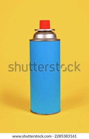 Blue cartridge bottle on yellow background