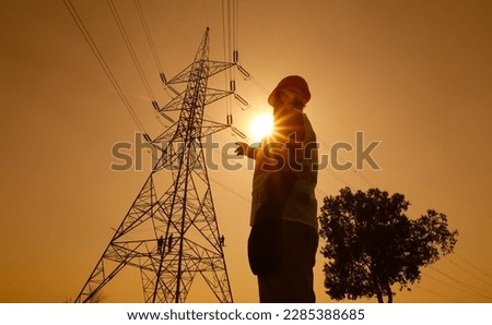 Electrical Engineer Working at high voltage power lines. high tension tower.