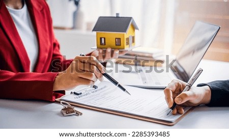 House model with real estate agent and customer discussing for contract to buy house, insurance or loan real estate background. Royalty-Free Stock Photo #2285393485