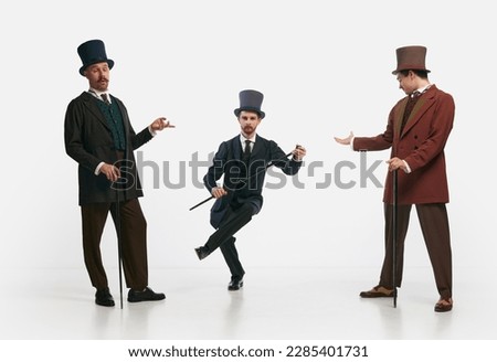 Gentlemen. Portrait with three men wearing old-fashioned clothes and posing over white background. Concept of historical remake, comparison of eras, retro, vintage, emotions, ad, mood