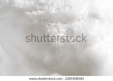 Photo of the texture of cosmetic foam or soap on a white background.