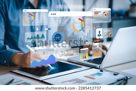 An analyst uses a computer and dashboard for data business analysis and Data Management System with KPI and metrics connected to the database for technology finance, operations, sales, marketing  Royalty-Free Stock Photo #2285412737