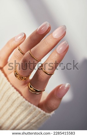 Female hands with rose nail design. Pink glitter nail polish manicure. Woman hands on white background.  Royalty-Free Stock Photo #2285415583