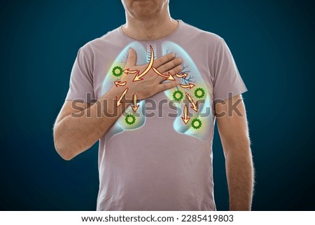 The man standing on a dark background. Picture of a human lungs with inflammation. Anatomy of respiratory system. Medical concept, internal organs diseases and viruses Royalty-Free Stock Photo #2285419803