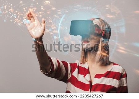 beatiful girl in VR glasses on gray background
