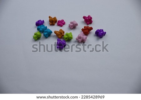 Differences, similarities.  Colorful elephants, photographed from above, placed on a white background.  Differences, similarities.  space, copy