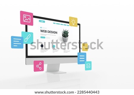 Concept of assembling a web page from modules that fly around the display. The web design studio concept page is on the display Royalty-Free Stock Photo #2285440443