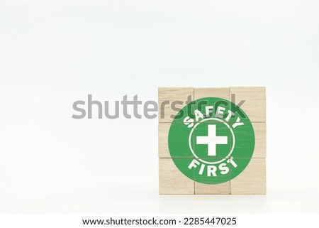 Safety first symbols on wooden cubes with white background. zero accident concept. Employees safety awareness at workplace. Safety banner.