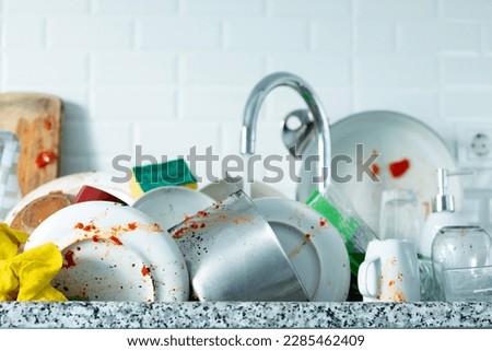 washing dirty dishes at home Royalty-Free Stock Photo #2285462409