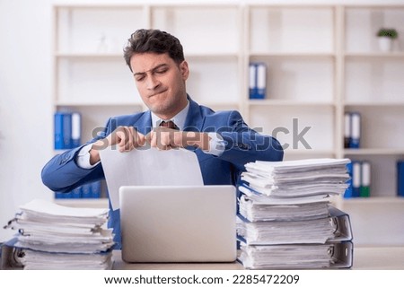 Young male employee working in the office Royalty-Free Stock Photo #2285472209
