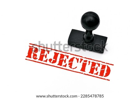 Wooden rubber stamp with the word rejected on the white paper Royalty-Free Stock Photo #2285478785