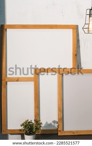 Empty wooden frames group in front of white wall 