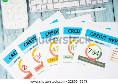 Credit score report document and pen with calculator on the desk.