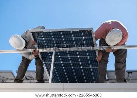 Installation of solar panels, in family residences. Royalty-Free Stock Photo #2285546383