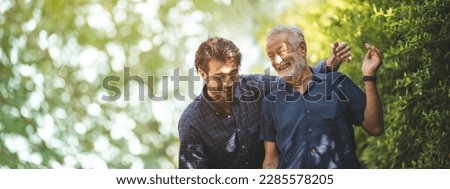 Adult hipster son fun hugging old senior father at home, two generations have a beard talking together and relaxing with smile, 2 man happy enjoy to living at home in father's day with love of family Royalty-Free Stock Photo #2285578205
