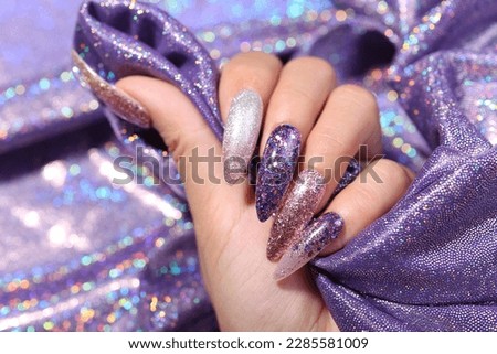 Female hand with silver nail design. Glitter silver nail polish manicure. Model hand with perfect manicure hold white lace fabric on white background. Royalty-Free Stock Photo #2285581009