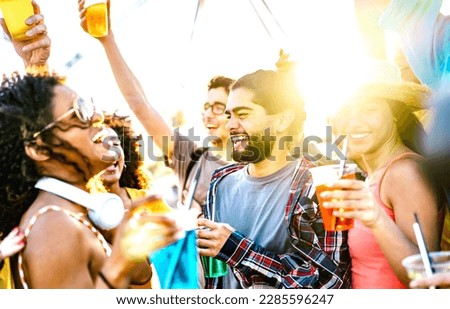 Trendy vacationers dancing at sunset concert on summer days - Fancy life style concept with guys and girls having genuine fun together at spring break party - Bright vivid filter with sunlight halo Royalty-Free Stock Photo #2285596247