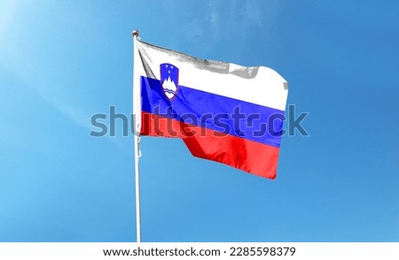 Slovenian flag in the cloudy sky. waving in the sky