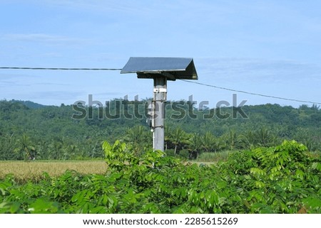 Houses for rat-eating birds in the fields