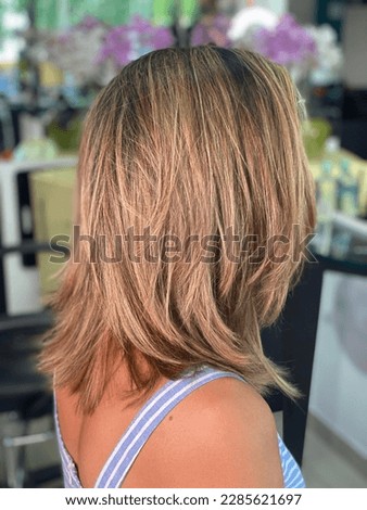 Beautiful long bob hair cut, with amazing balayage colors. Brunette with honey color highlights. Royalty-Free Stock Photo #2285621697
