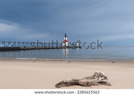 Storm clouds approaching St. Joseph lighthouse and beach.  St. Joseph, Michigan, USA. Royalty-Free Stock Photo #2285625563
