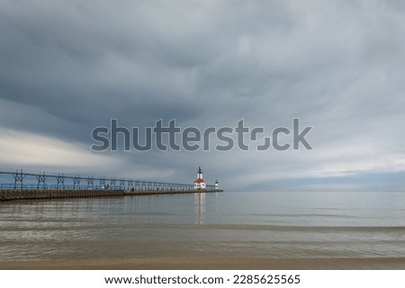Storm clouds approaching St. Joseph lighthouse and beach.  St. Joseph, Michigan, USA. Royalty-Free Stock Photo #2285625565